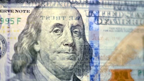 Macro view of rotating hundred dollar bill with detailed engraving of benja.. Stock Footage 339638986