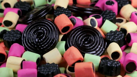 Macro view with rotation of licorice gummy candies. Colorful chewy sweets. Video stock 170674034