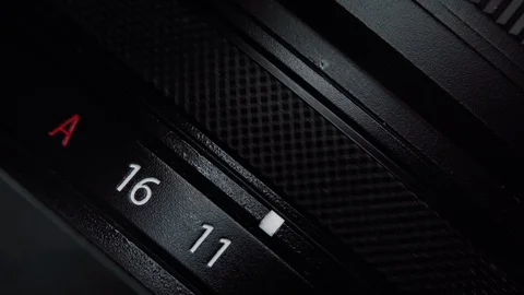 Macro view of rotation mirrorless or DSLR camera aperture ring. Changing the Stock Footage 129774208