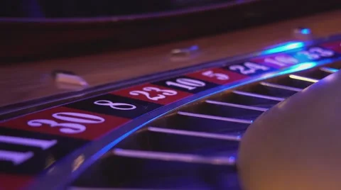 Macro view on a Roulette Wheel in a casino - ball falling in field 30 red 動画素材 56980484
