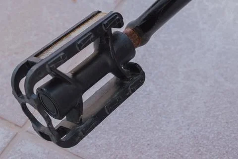 Macro view of rusty joint on black plastic pedal of kids bicycle needing re.. Stock Photos