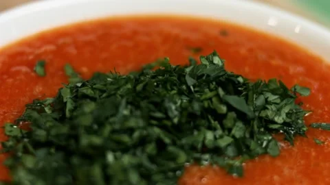 Macro view of salsa and chopped fresh parsley in a bowl. Process of making salsa Stock Footage 151174513