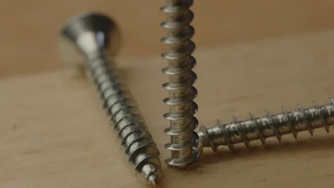 Macro view of screw being drilled out of wooden board in slow motion Stock Footage 261129232