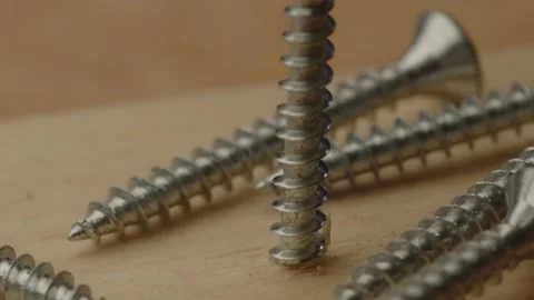 Macro view of screw rotating into wooden beam in 240fps slow motion Stock Footage 261129124