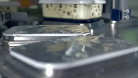 A macro view on sealed curd containers during labeling. Stock Footage