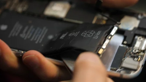 Macro view serviceman takes out accumulator from corpus Stock Footage 104655481