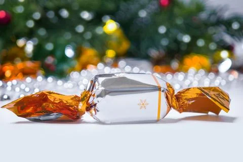 Macro view of a shiny silver and gold wrapped christmas candy with snowflak.. Stock-Fotos