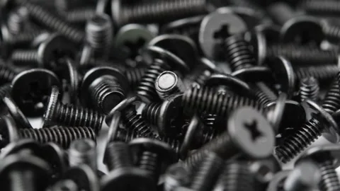 Macro view shows black screws rotating for electronics, computer repair and Stock Footage 346876241