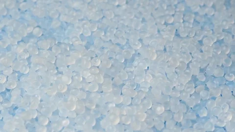 Macro view shows rotating polymer pellets as raw material for healthcare, Stock Footage 347048815