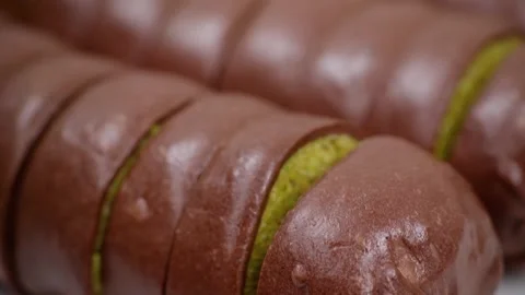 Macro View of Sliced Chocolate Bread Roll with Vibrant Matcha Green Tea Filling Stockbeeldmateriaal 337751702