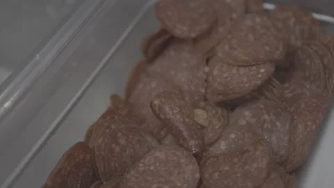 Macro View of Sliced Dry Salami or Pepperoni in Plastic Container 4K Stock Footage 329325556
