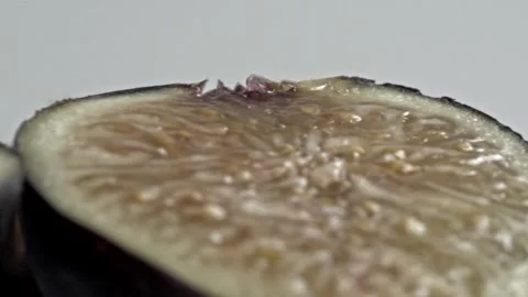 Macro View of Sliced Fig Spinning to Reveal Its Detailed Interior Texture Stock Footage 345365635