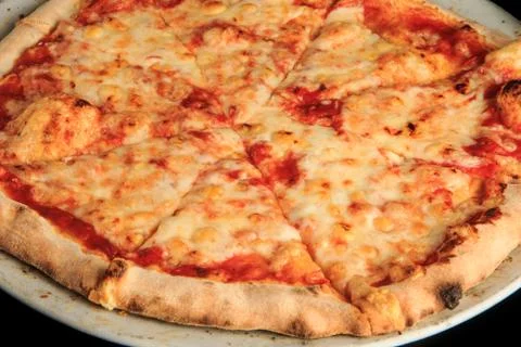 Macro view of sliced four cheese pizza on black background 스톡 사진