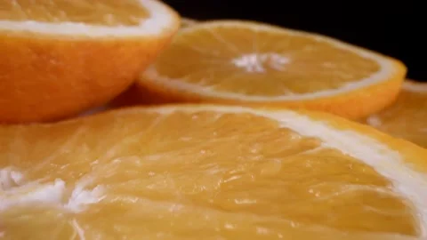 Macro view on sliced orange in black background, closeup view of juicy pulp and Stock Footage 236534626