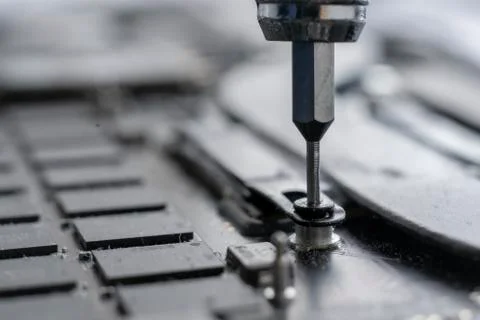 A macro view small screwdriver screw and repair the detail inside the computer Foto stock