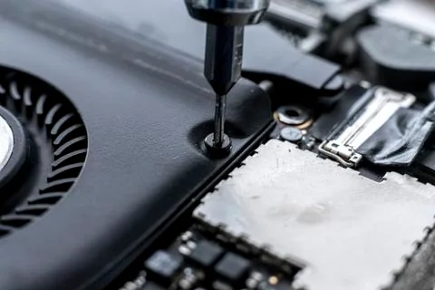 A macro view small screwdriver screw and repair the detail inside the computer Stock Photos