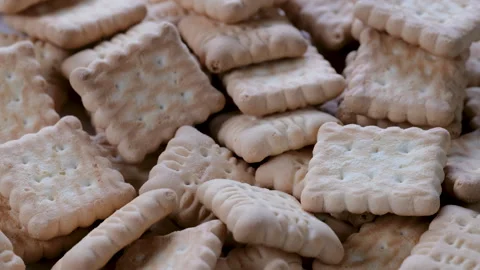 Macro view of small-sized brown petits beurre-style biscuits cracker stacked Stock Footage 296532863