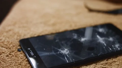 Macro view of smartphone laying on a surface. Someone mad breaking the Stock Footage 144935314