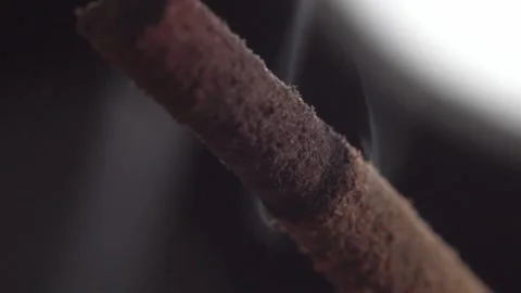 Macro View of Smoldering Incense Stick with Wisps of Smoke and Ash Texture Stock Footage 338412955