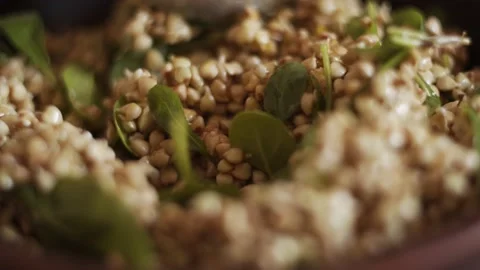 Macro view of sprouted raw green buckwheat with spinach and vegetable oil. Vegan Stock Footage 152043600