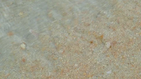 Macro View of Tidal Water Carrying Sand Across Shallow Shoreline 스톡 동영상 337612706