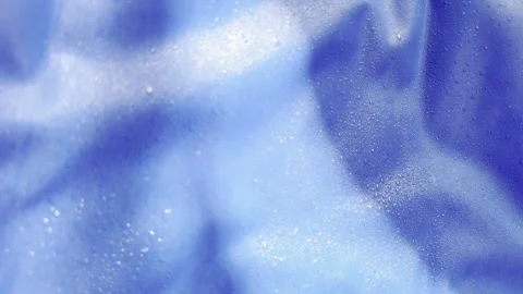 Macro view of tiny water drops condensing and shimmering on a crumpled blue.. Vídeos de archivo 335139429