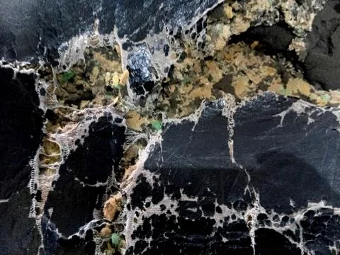 Macro View of Torn Black Leather and Foam Stock Photos