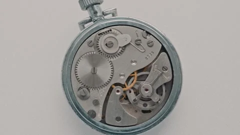 Macro View Of Vintage Mechanical Stopwatch Movement Rotating On White Stock Footage 328610040