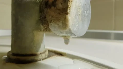 Macro view of water flows in an old chrome faucet covered with limescale. Stock Footage 165951793