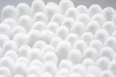 Macro view of white cotton ear cleaning buds arranged in white background Stock Photos