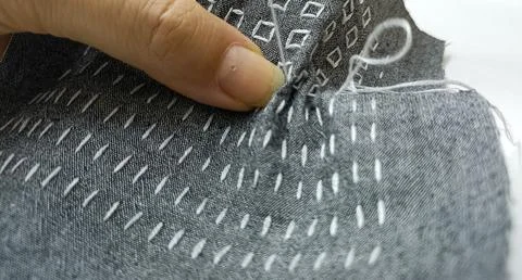 Macro View of White Hand Stitches on Dark Fabric – Visible Mending Detail Stock Photos
