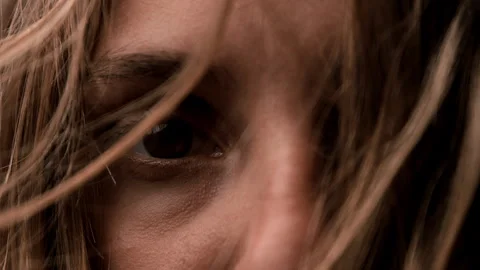Macro View of Woman's Eye with Blonde Hair Blowing Across Face in Slow Motion Stock Footage 270405063