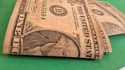 Macro view of worn one dollar bills on green surface Stock Photos