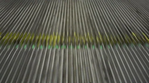 A macro view of a yellow and grey escalator stairs Stock Footage 59194199