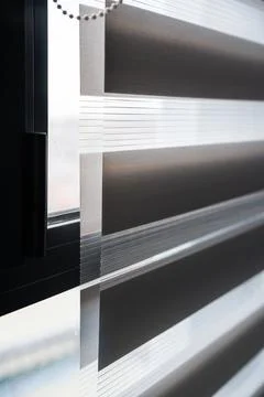 Macro view of zebra blind fabric layers with sunlight shining through 스톡 사진
