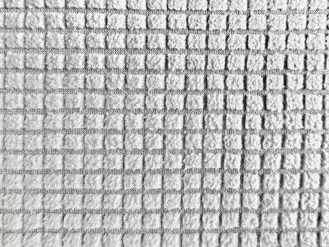 Macro waffle knit texture light grey fabric background soft domestic wellness Stock Photos