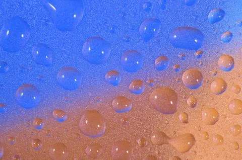 Macro of water drops on colored background. Selective focus. Stock Photos