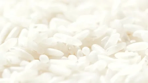 Macro white raw rice grain falling down, food background, slow motion video 库存影片 142670229