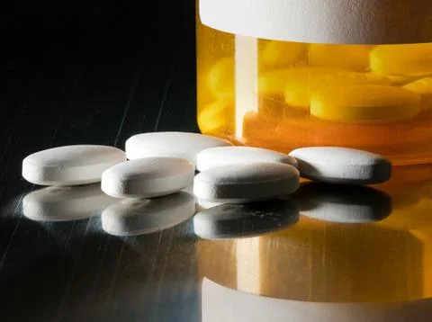 Macro of white tablets on metal table Stock Photos