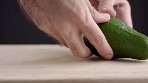 Macro wide close up of knife slicing and chopping a green avocado Stock Footage 273511352