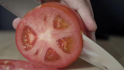 Macro wide close up of knife slicing and chopping a red tomato salad, food, Stock Footage 273511677