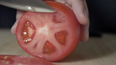Macro wide close up of knife slicing and chopping a red tomato salad, food, Stock Footage 273511817