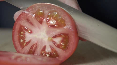 Macro wide close up of knife slicing and chopping a red tomato salad, food, Stock Footage 273511878