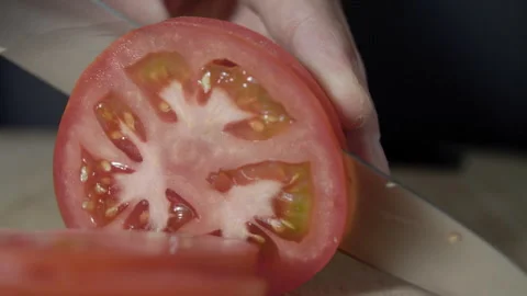 Macro wide close up of knife slicing and chopping a red tomato salad, food, Stock Footage 273512259