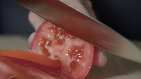 Macro wide close up of knife slicing and chopping a red tomato salad, food, Stock Footage 273512279