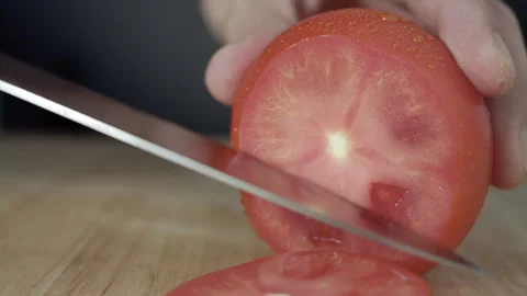Macro wide close up of knife slicing and chopping a red tomato salad, food, Stock Footage 273512315
