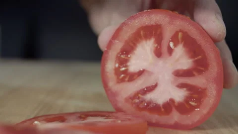Macro wide close up of knife slicing and chopping a red tomato salad, food, Stock Footage 273512335