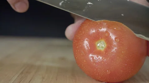 Macro wide close up of knife slicing and chopping a red tomato salad, food, Stock Footage 273512493