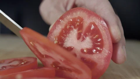 Macro wide close up of knife slicing and chopping a red tomato salad, food, Stock Footage 273512513