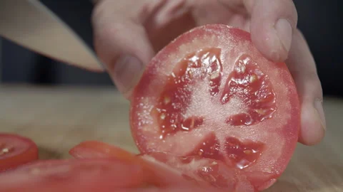Macro wide close up of knife slicing and chopping a red tomato salad, food, Stock Footage 273512573